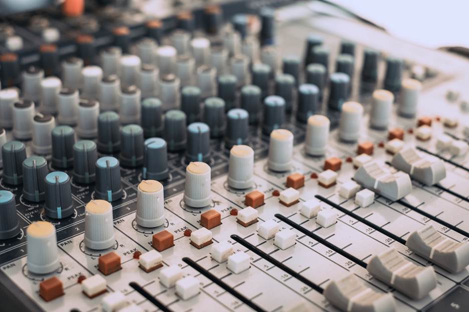 Audiovisual control panel with dials, buttons, slider controls, and LED indicators